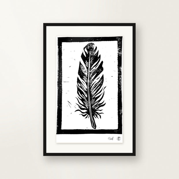 Feather — hand-printed linocut, framed on the wall